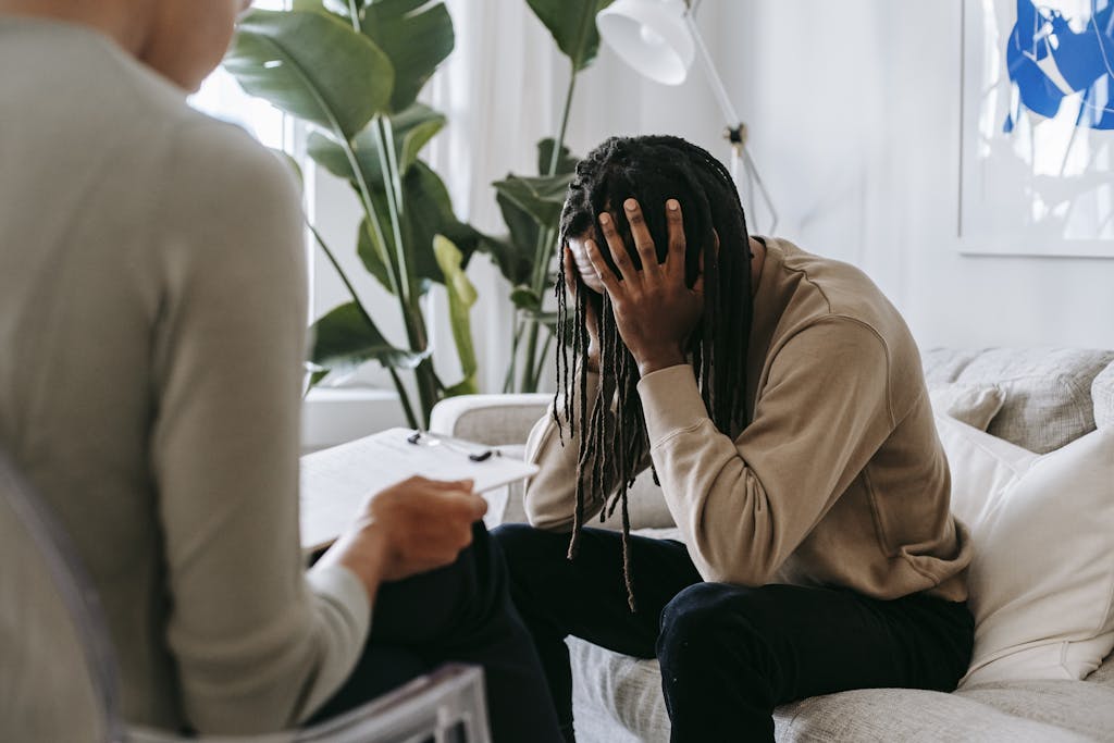 Stressed man with dreadlocks in psychological office